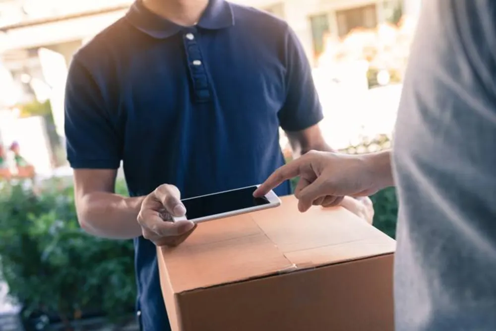 Courier handing over a delivery package at the door
