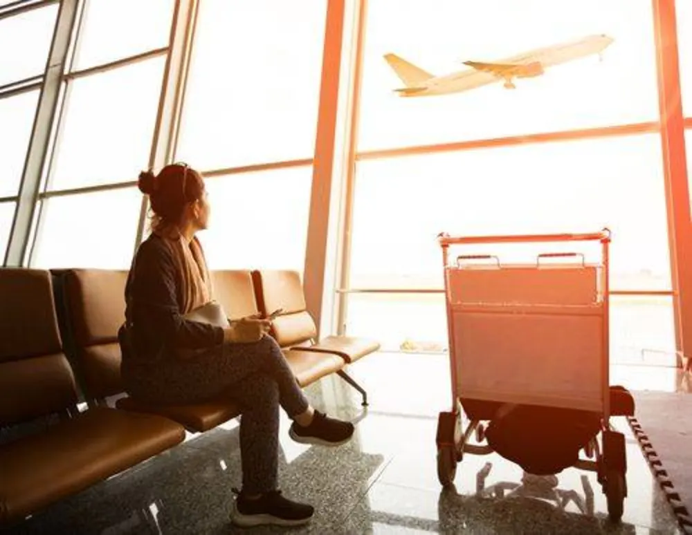 Traveler with a backpack walking through an airport terminal